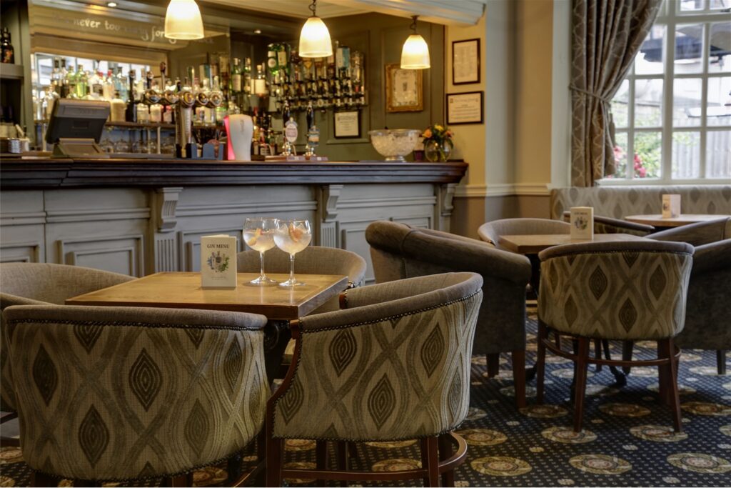 Tables and upholstered chairs beside the counter in the Lounge Bar.