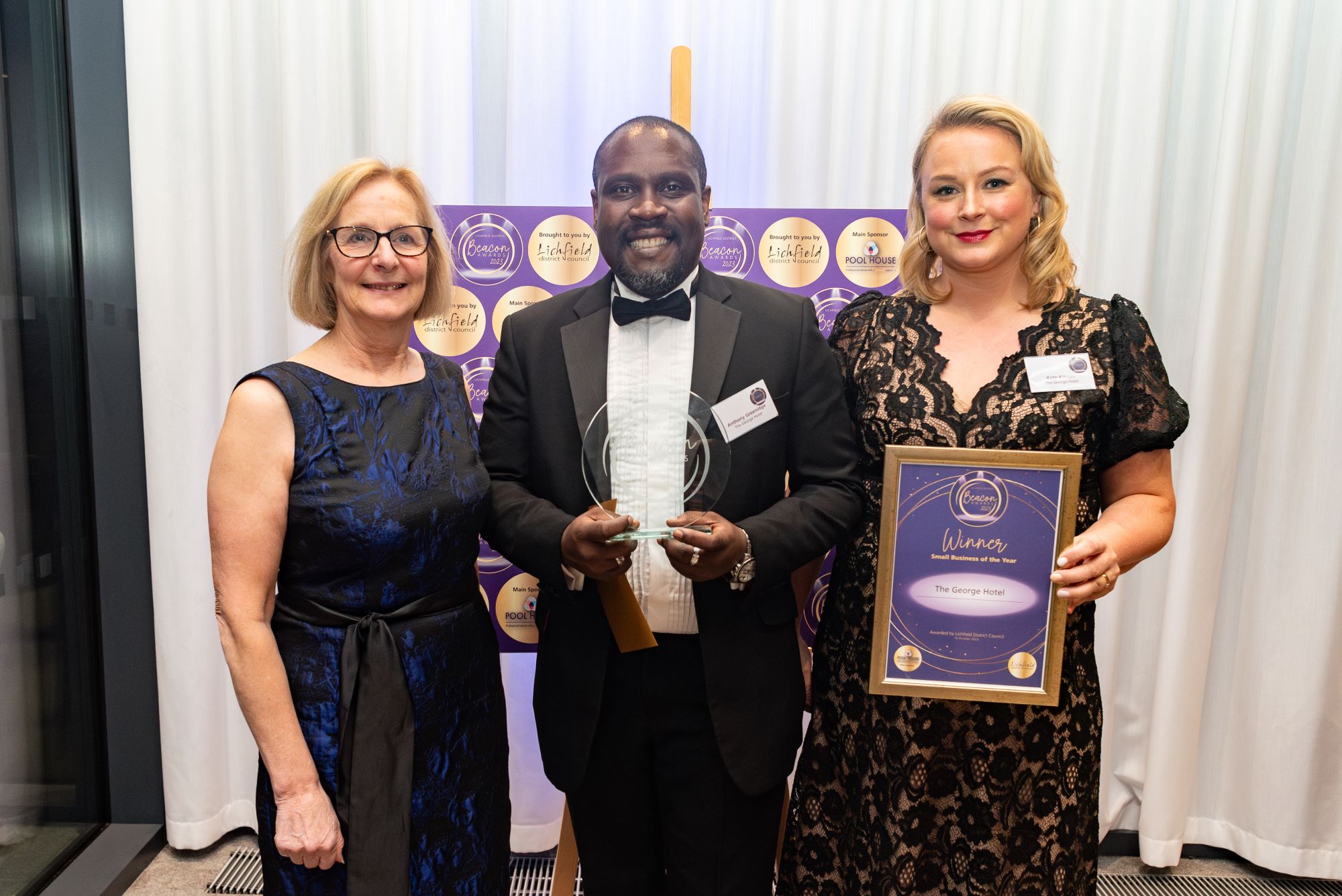 Three people holding an award and certificate at the Lichfield District Beacon Awards.